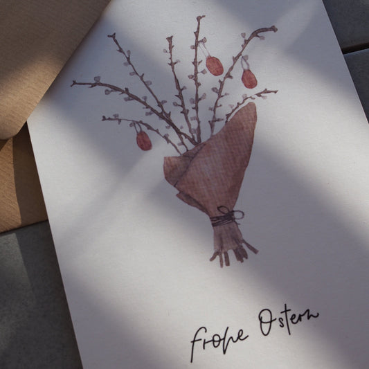 Aquarellierte Osterstrauch, eingewickelt in braunem Papier mit roten Eiern. Text: ,,frohe Ostern''.