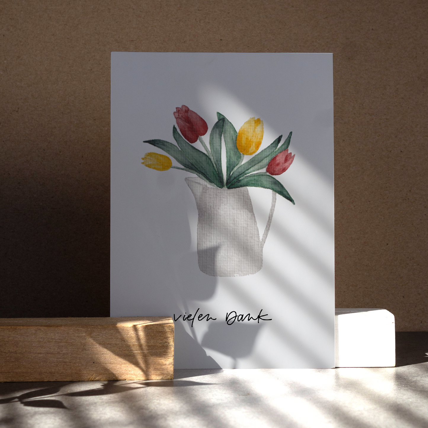 Aquarell-Postkarte DIN A6, Hochformat, Recyclingpapier, gedruckt in Deutschland. Gelbe uns rote Tulpen in einer grau-weißen Kanne. Text: ,,vielen Dank''. Nahansicht.